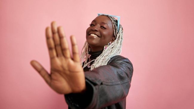 Image of woman holding her hand out to stop something and indicate a boundary