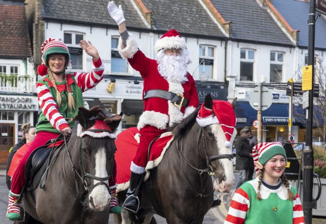 Santa and his Elves on horseback at Christmas in the Village